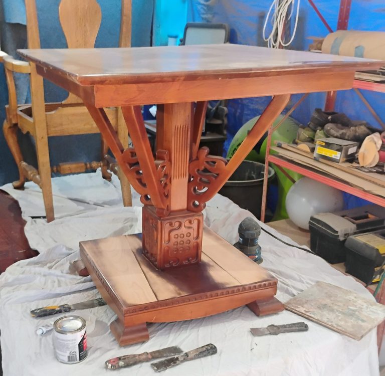 Refinished wooden table with a smooth, polished surface by The Strip Joint Restoration.