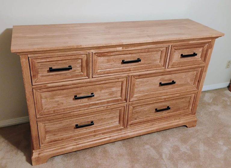 Craftsman repairing and refinishing wood furniture in workshop at The Strip Joint Restoration.